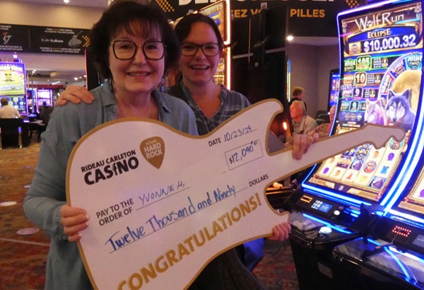 Casino jackpot winner at Rideau Carleton holding jackpot sign