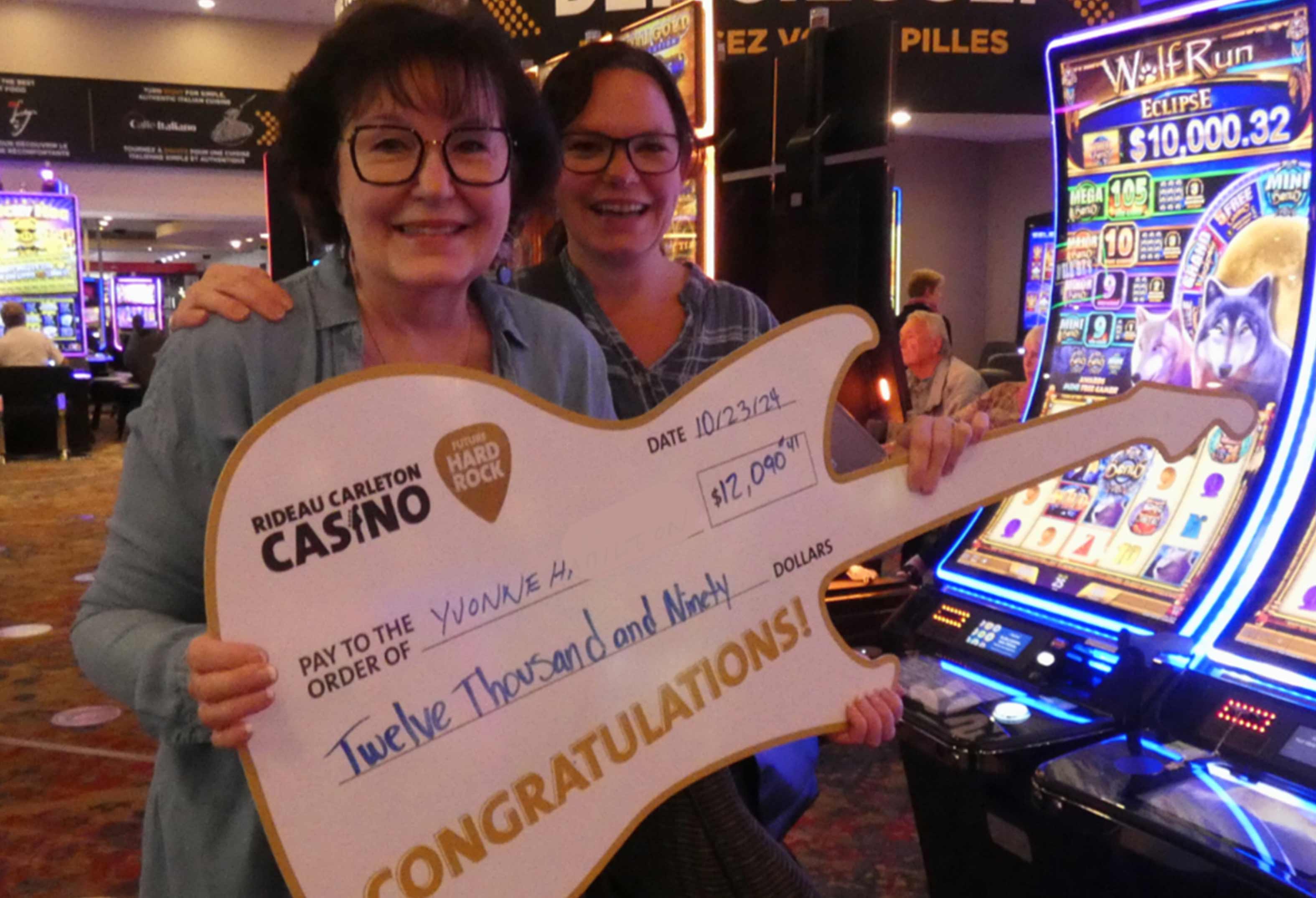 Casino jackpot winner at Rideau Carleton holding jackpot sign
