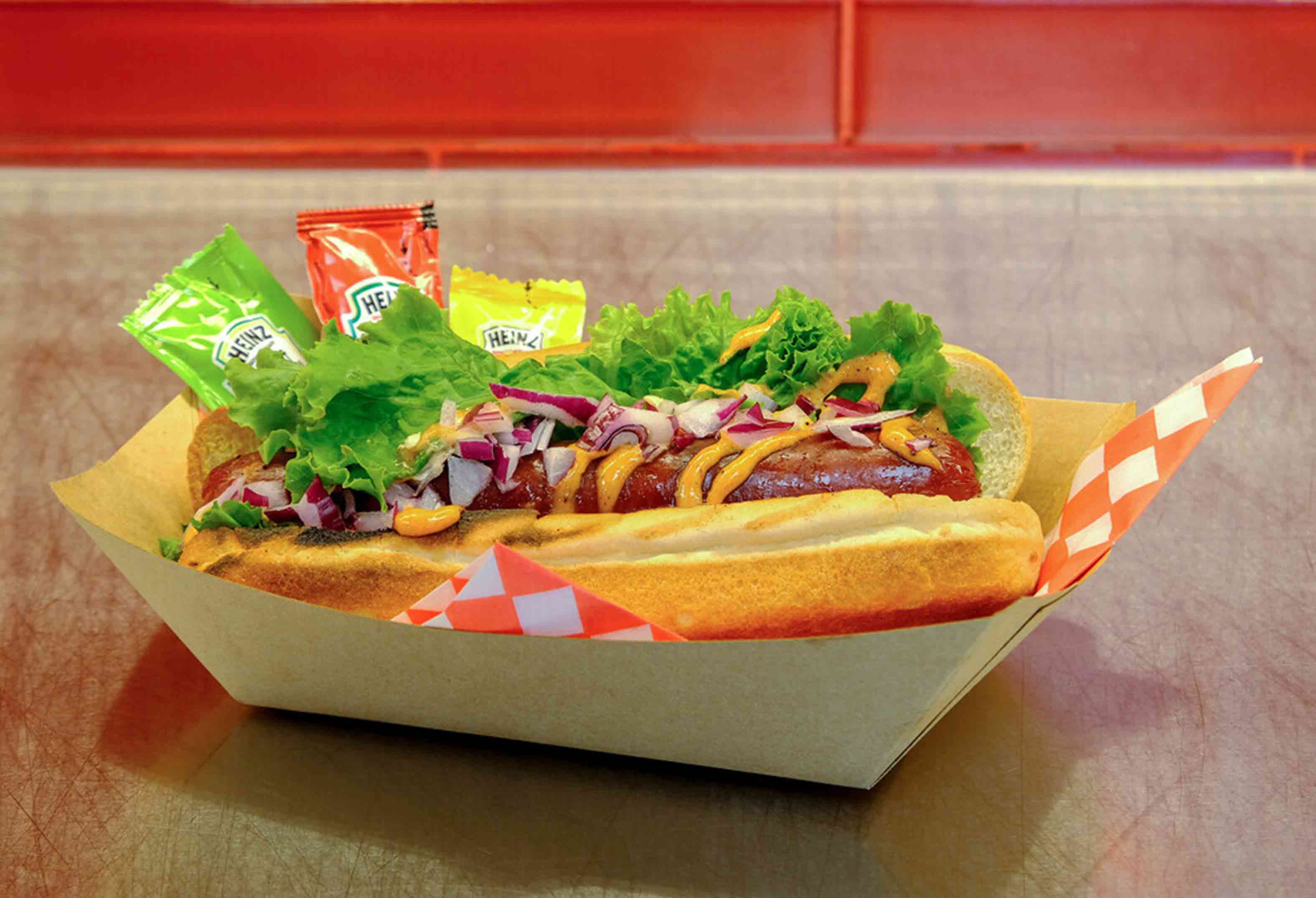 Hot dog with condiments at Mr. Lucky's
