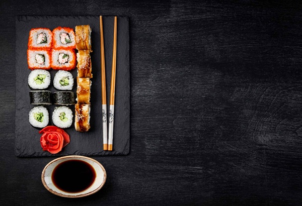 sushi rolls with soy sauce and chop sticks