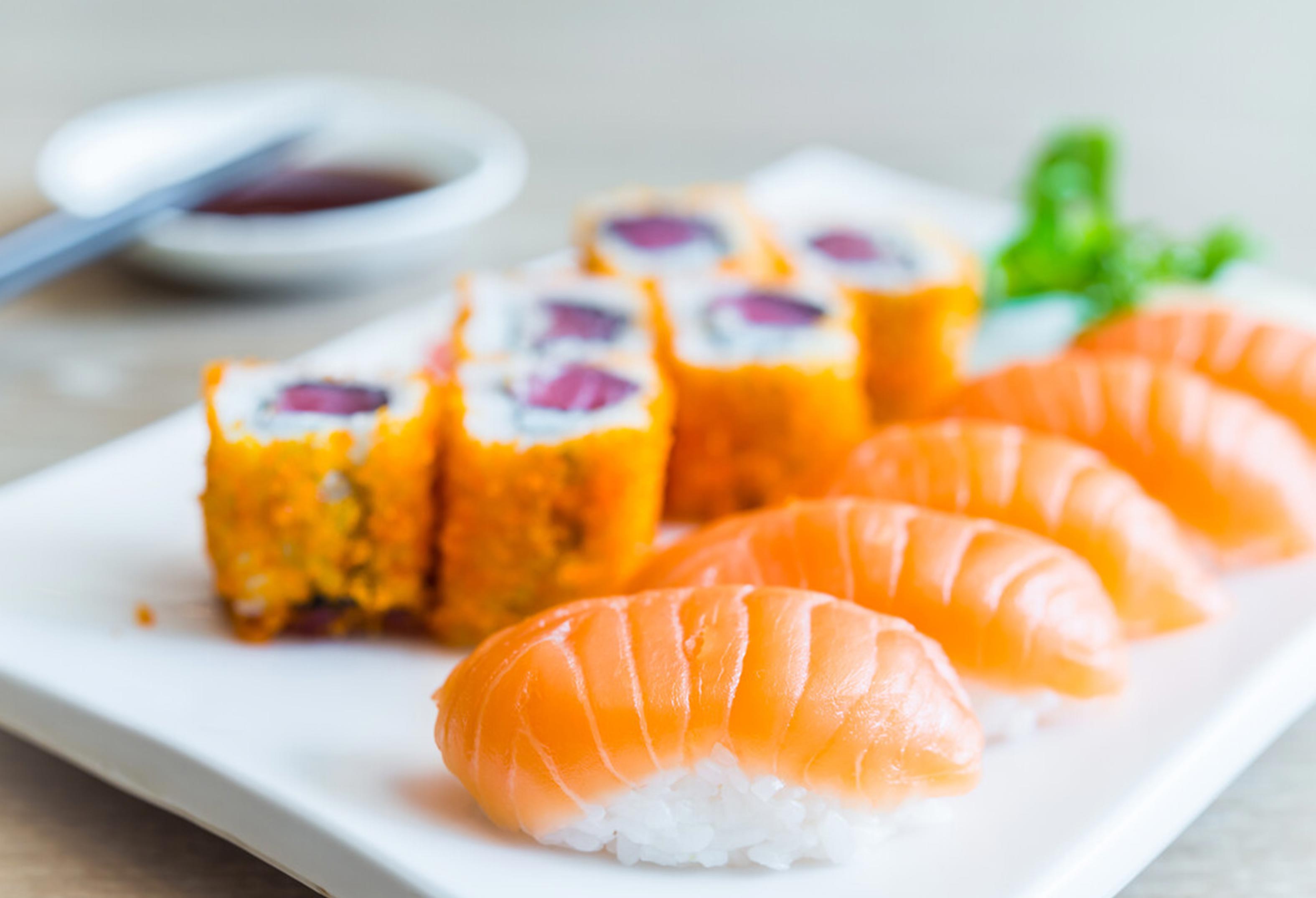 sushi roll and sushi on a plate with soy sauce