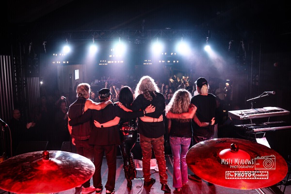 Music group bowing for a crowd in a concert venue