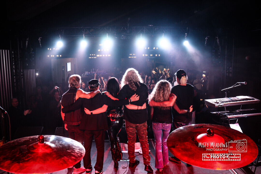 Music group bowing for a crowd in a concert venue