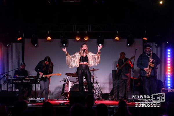 Woman singing for a large crowd