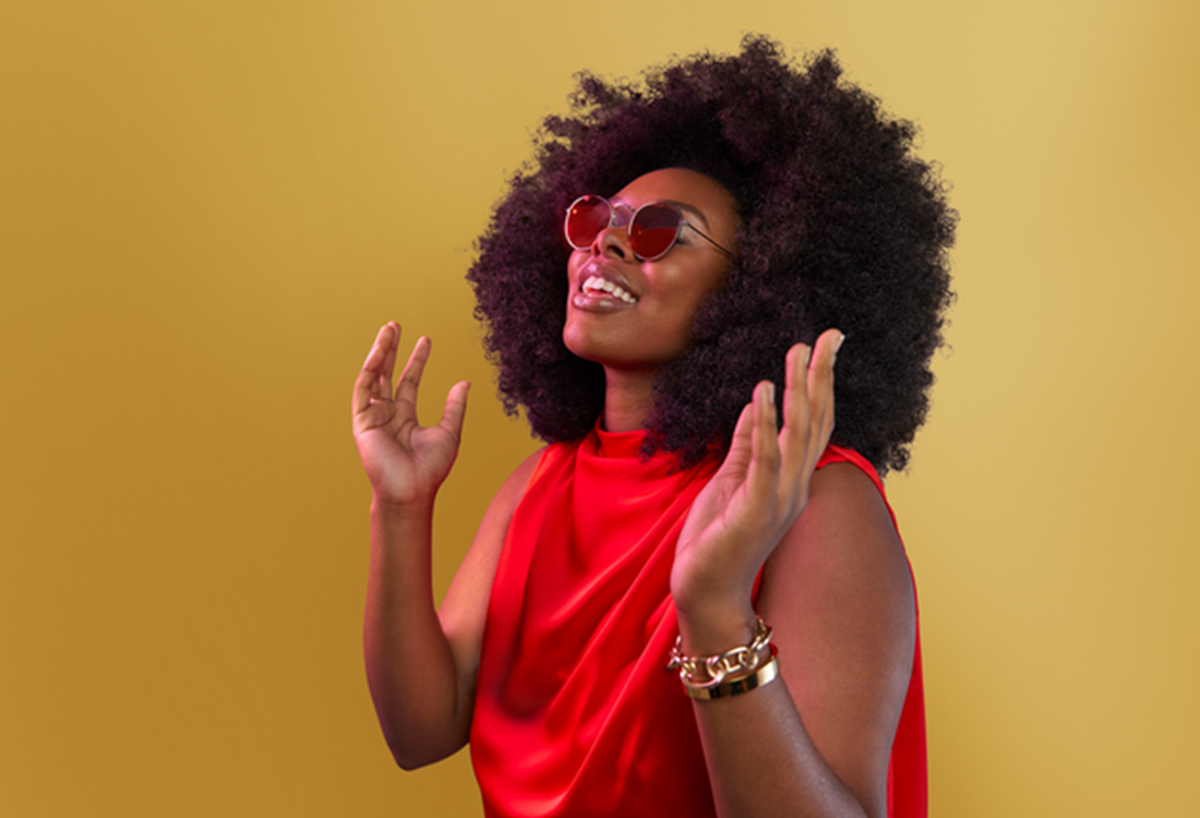 woman holding her hands up smiling